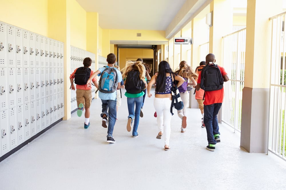 AtlasIED students running in hallway of middle school or primary school